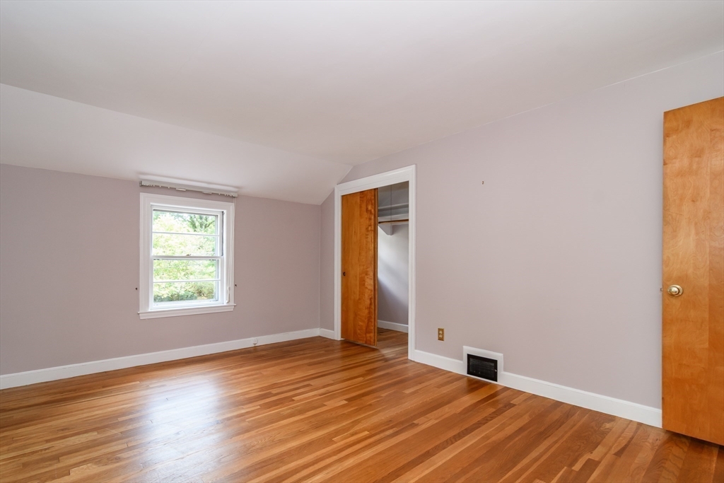 115 Parker Road Wellesley, MA 02482 - Photo 13 of 22 a view of an empty room with wooden floor and a window