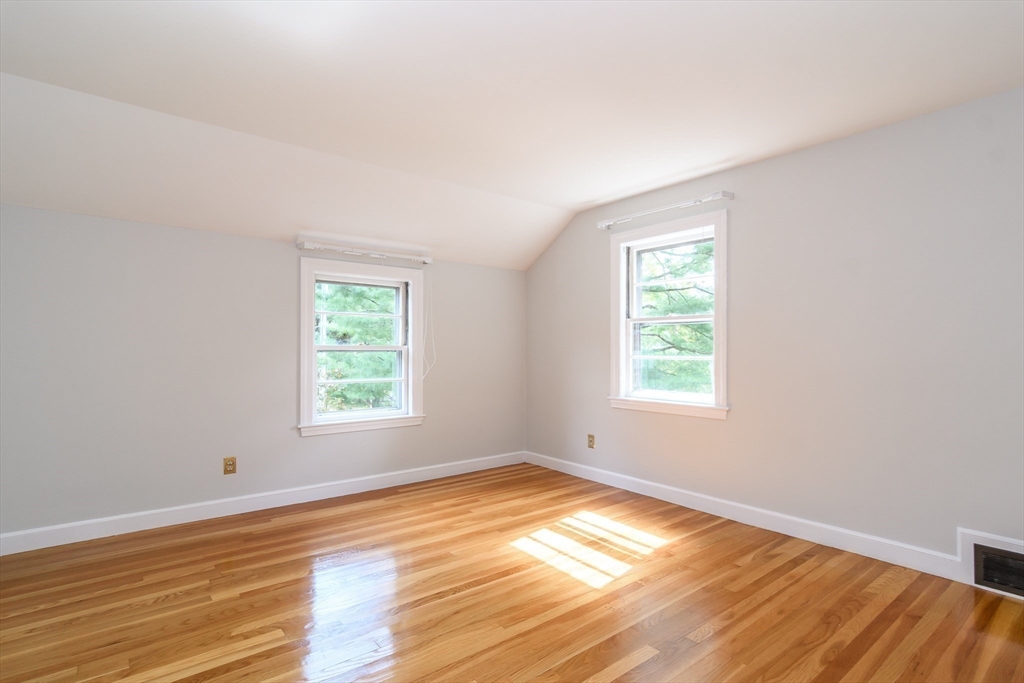 115 Parker Road Wellesley, MA 02482 - Photo 18 of 22 an empty room with wooden floor and windows