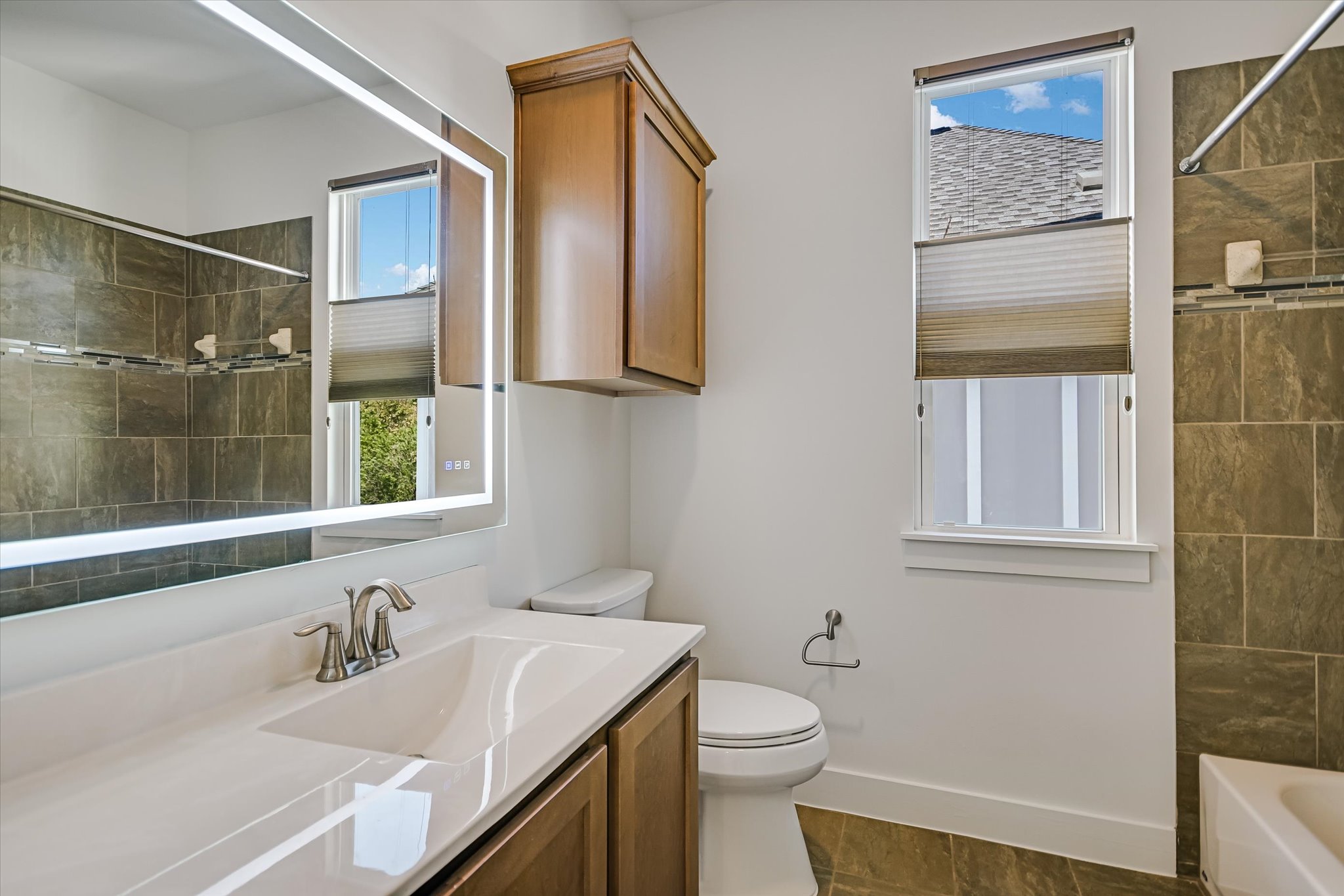 924 Sugaree Avenue Austin, TX 78757 - Photo 15 of 20 Bathroom featuring vanity and dark tile patterned floors