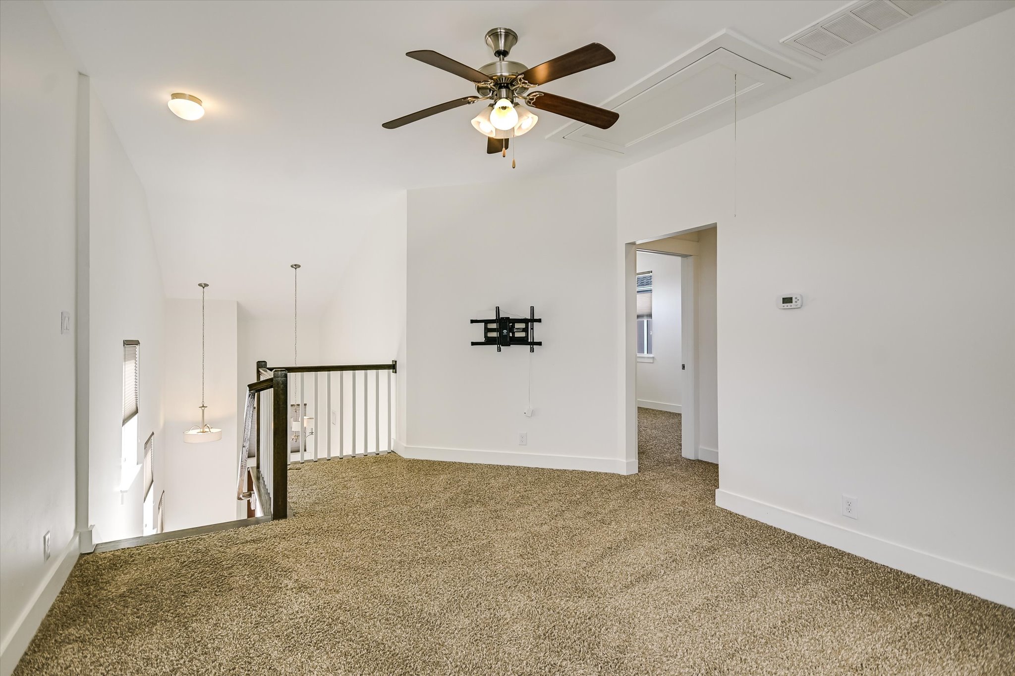 924 Sugaree Avenue Austin, TX 78757 - Photo 10 of 20 Spare room with attic access, carpet flooring, and ceiling fan