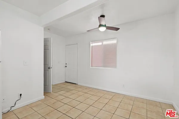 a white toilet sitting next to a bath tub