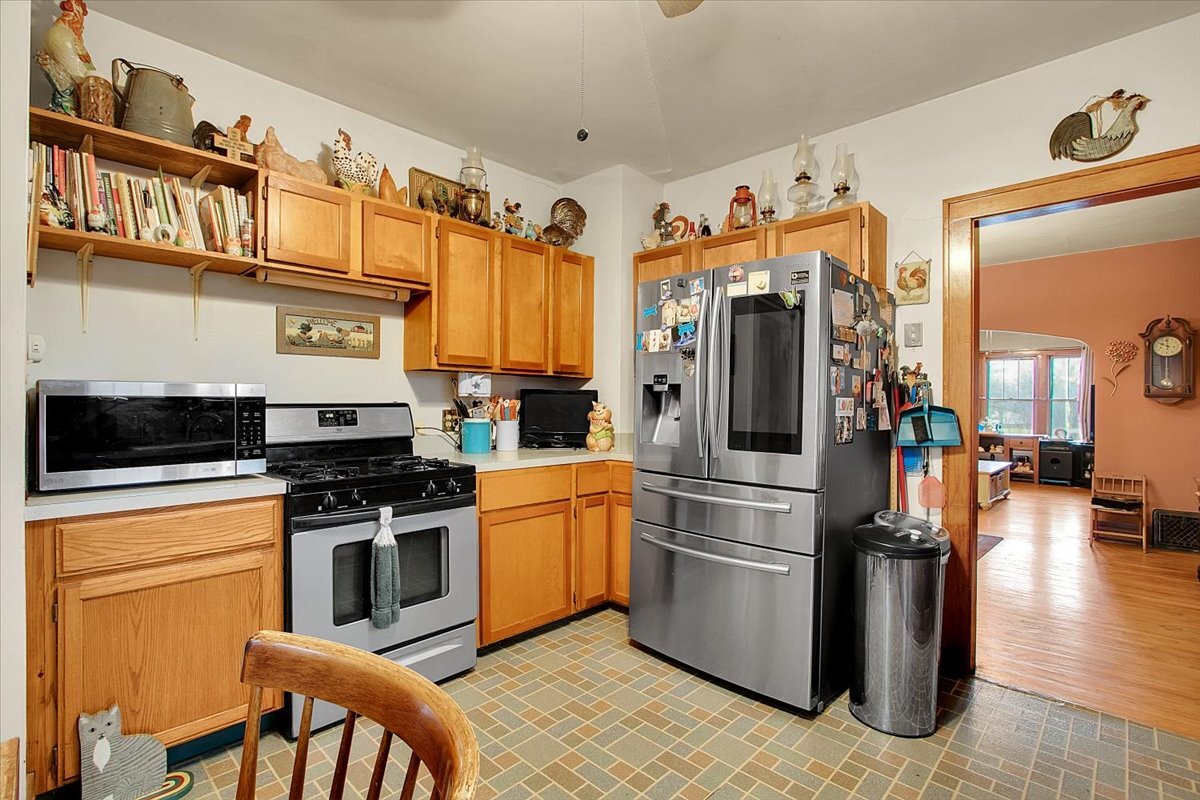 24447 Caton Farm Road Plainfield, IL 60586 - Photo 12 of 27 a kitchen with stainless steel appliances granite countertop a refrigerator a stove and a sink