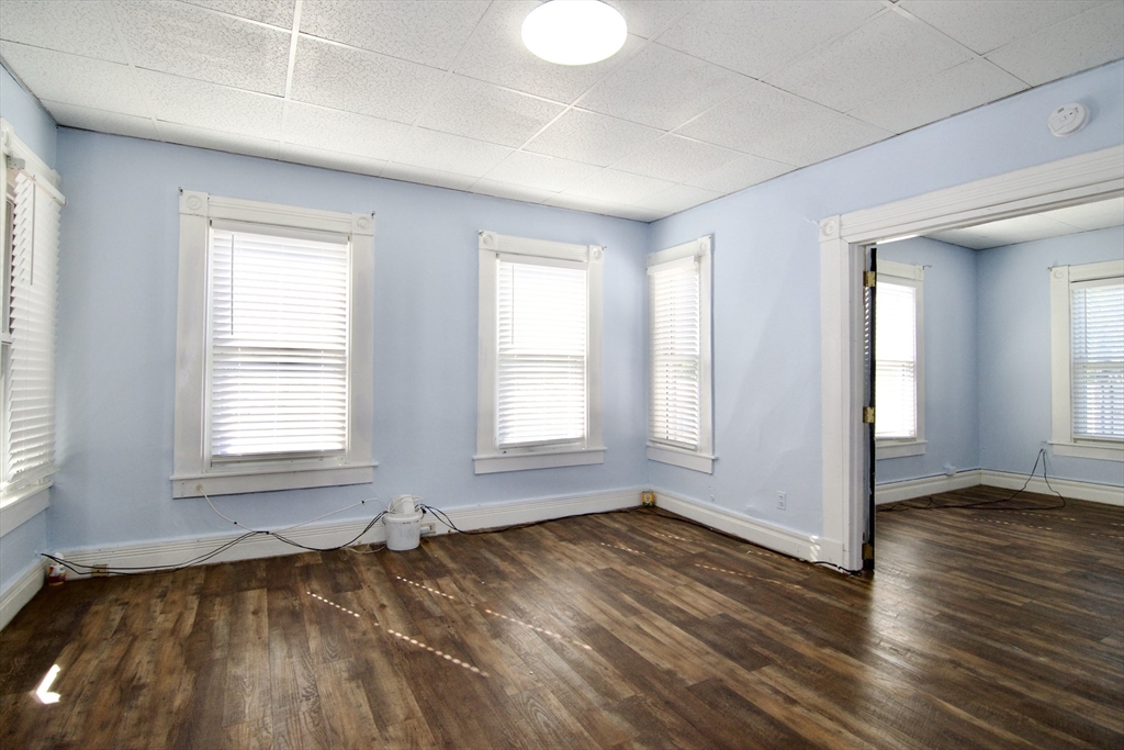 425 Taylor Street, Unit 2 Springfield, MA 01105 - Photo 13 of 28 an empty room with wooden floor and windows