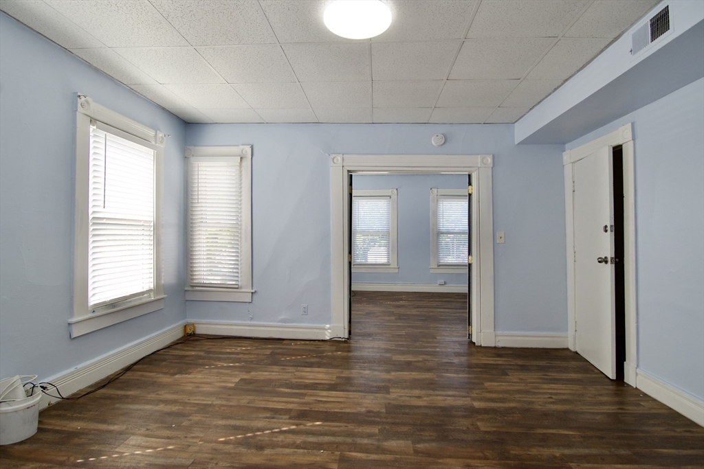 425 Taylor Street, Unit 2 Springfield, MA 01105 - Photo 14 of 28 an empty room with wooden floor and windows