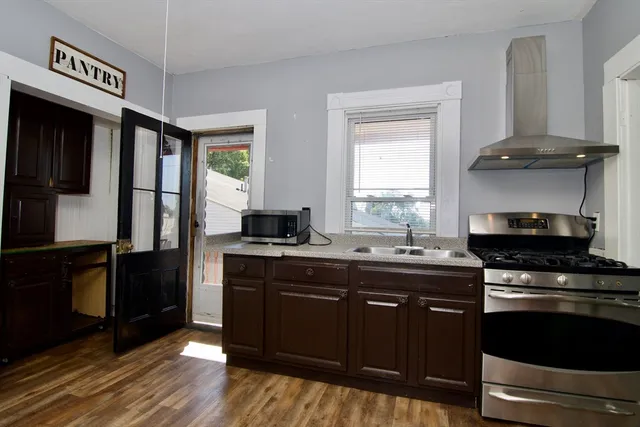 a kitchen with a sink stove and refrigerator