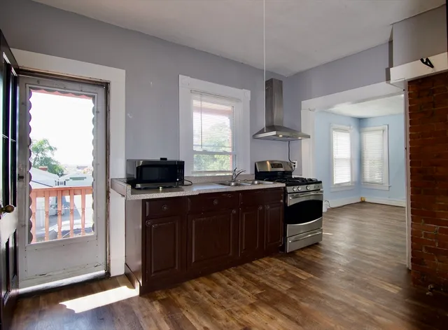 a kitchen with stainless steel appliances granite countertop a stove and a sink