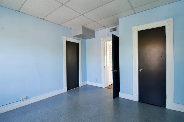 an empty room with closet and wooden floor