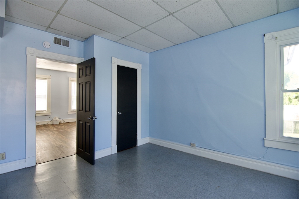425 Taylor Street, Unit 2 Springfield, MA 01105 - Photo 22 of 28 an empty room with wooden floor and a window