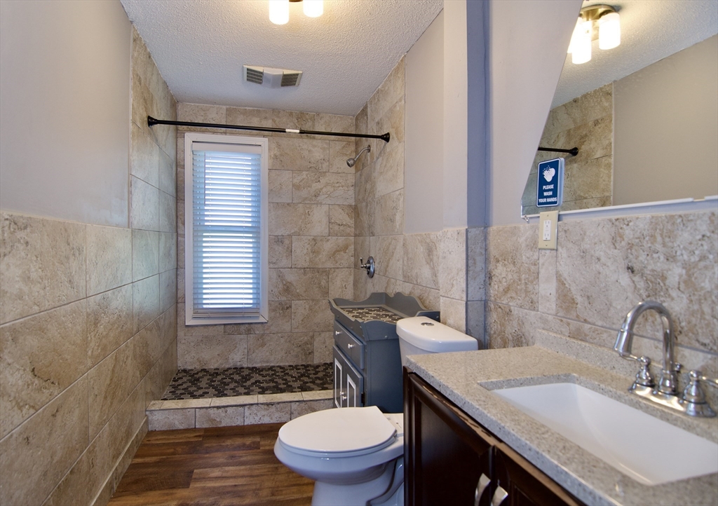 425 Taylor Street, Unit 2 Springfield, MA 01105 - Photo 24 of 28 a bathroom with a sink toilet a mirror and shower