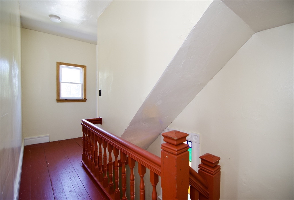 425 Taylor Street, Unit 2 Springfield, MA 01105 - Photo 5 of 28 a view of a livingroom with wooden floor and stairs