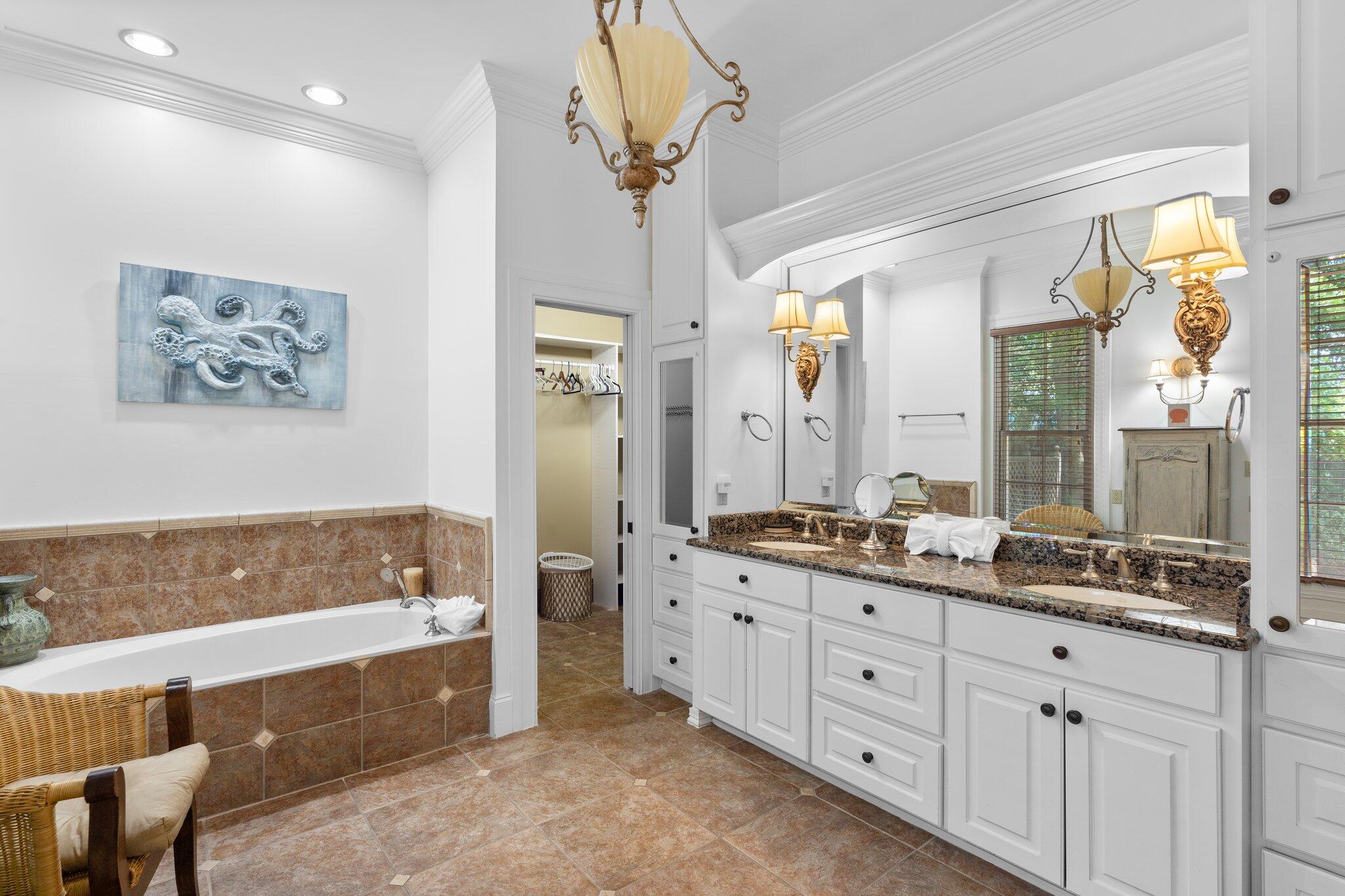 176 Rue Martine Miramar Beach, FL 32550 - Photo 26 of 82 a bathroom with a double vanity sink a large mirror a bathtub and next to a window