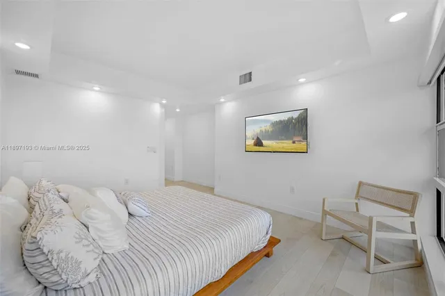 a bedroom with a bed and a chair