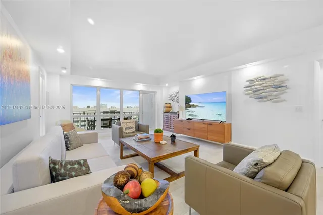 a living room with furniture and kitchen view