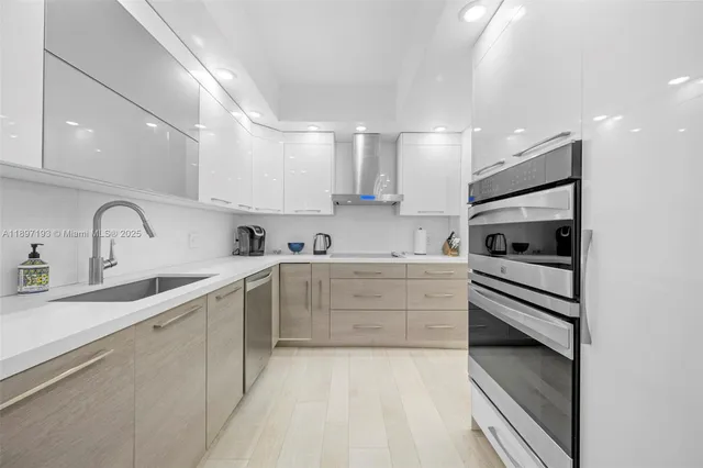 a kitchen with white cabinets and appliances