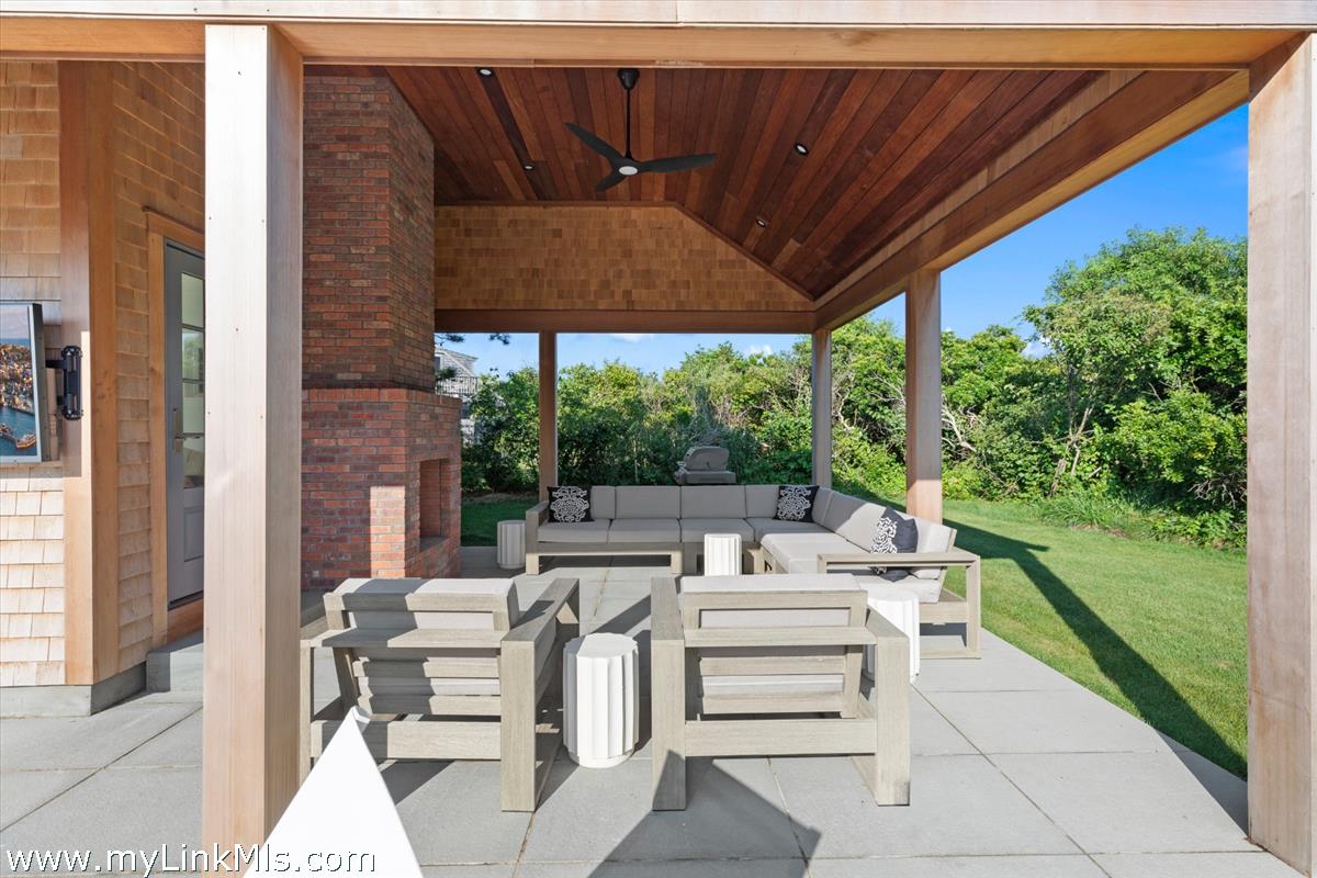 3 Tautemo Way Nantucket, MA 02554 - Photo 9 of 57 a view of a patio with table and chairs potted plants with floor to ceiling window