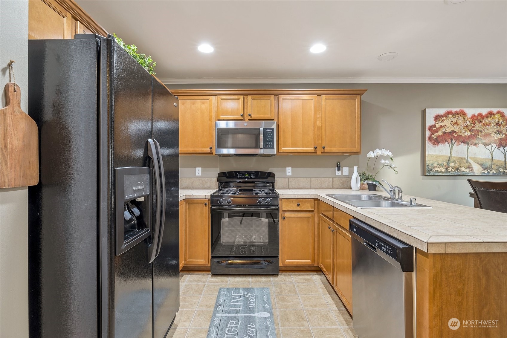 16603 42nd Avenue Southeast Bothell, WA 98012 - Photo 11 of 35 a kitchen with stainless steel appliances granite countertop a refrigerator a sink a stove and island