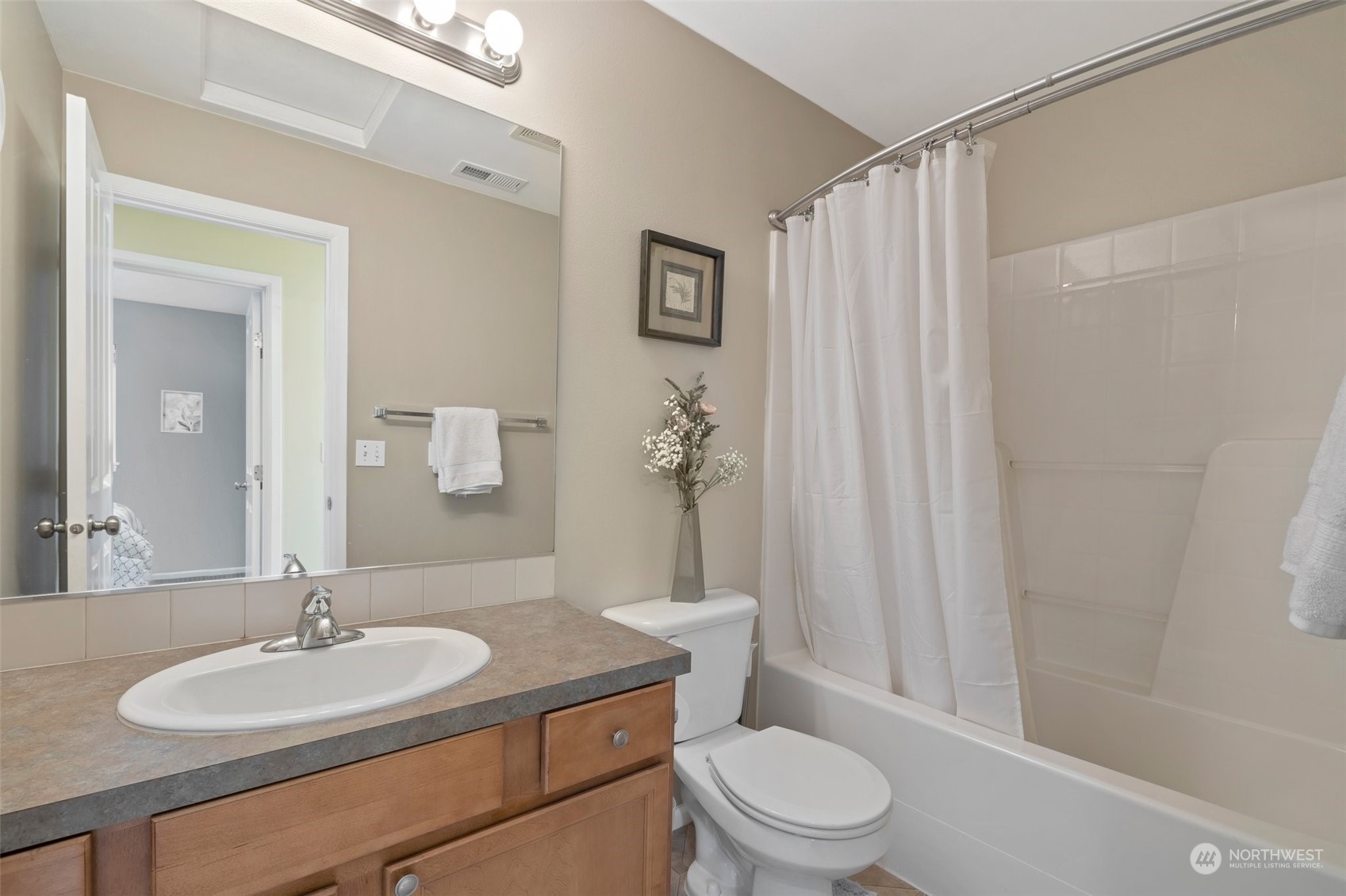 16603 42nd Avenue Southeast Bothell, WA 98012 - Photo 21 of 35 a bathroom with a granite countertop sink toilet a mirror and shower