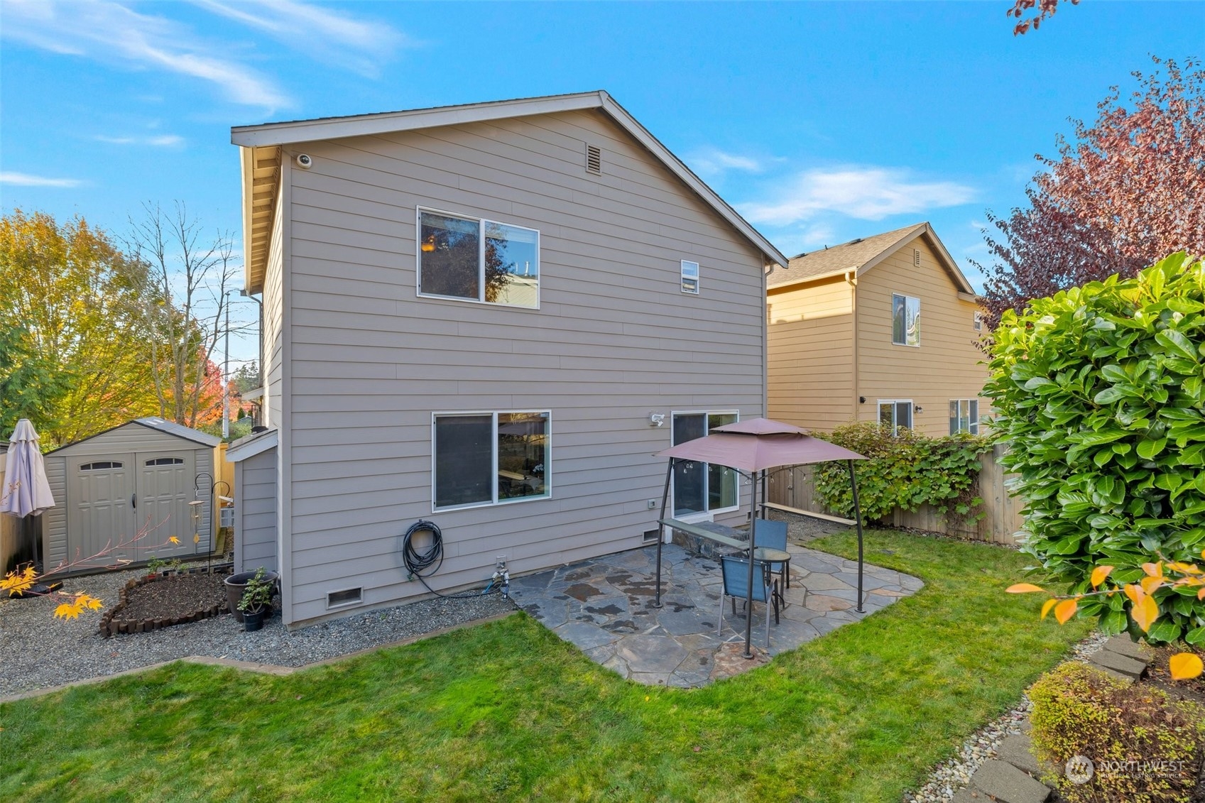 16603 42nd Avenue Southeast Bothell, WA 98012 - Photo 24 of 35 a view of a backyard with table and chairs and potted plants