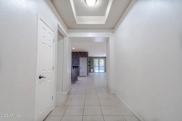 a view of a hallway with wooden shelves