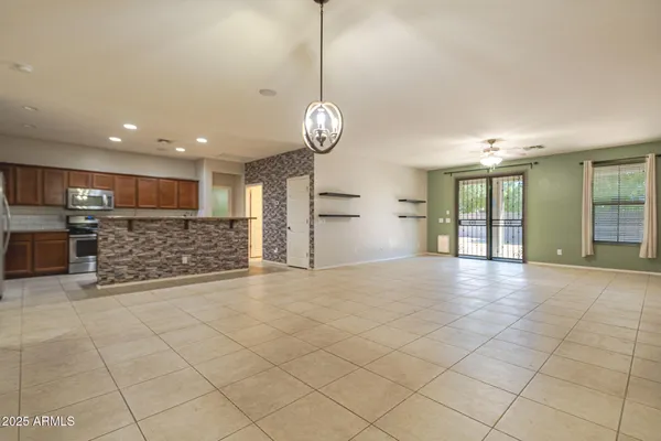 a view of an empty room with a kitchen