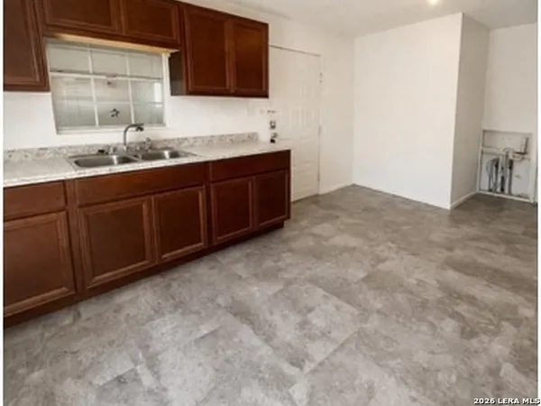a kitchen with a sink and cabinets