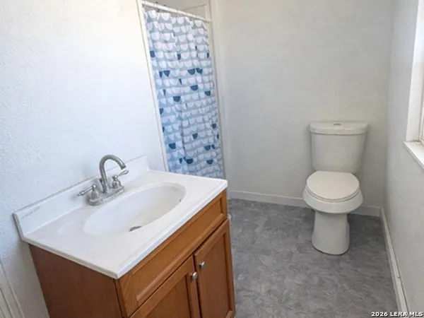 a bathroom with a sink toilet and a mirror