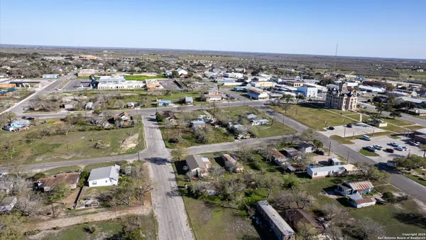 an aerial view of a house with outdoor space