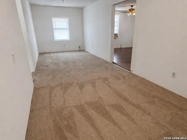 an empty room with windows and bathroom