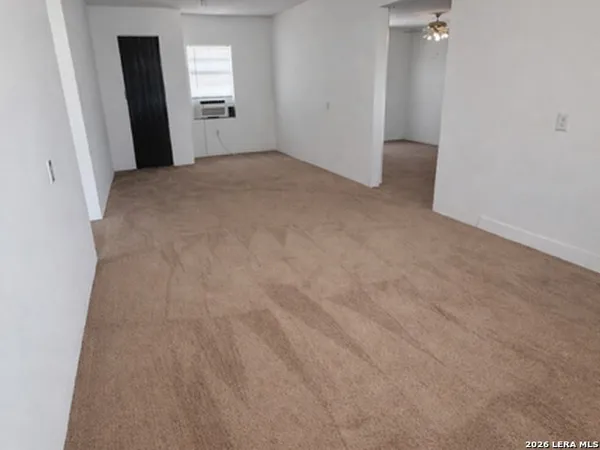 a view of a big room with closet and wooden door