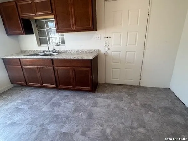 a room with a sink and cabinets