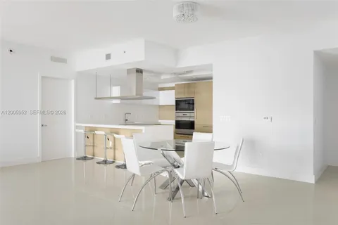 a kitchen with cabinets and chairs