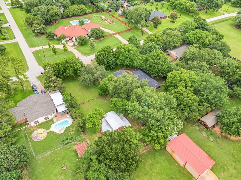 1805 Renfro Road Colleyville, TX 76034 - Photo 39 of 40 Expansive green property featuring multiple structures, a swimming pool, and mature trees