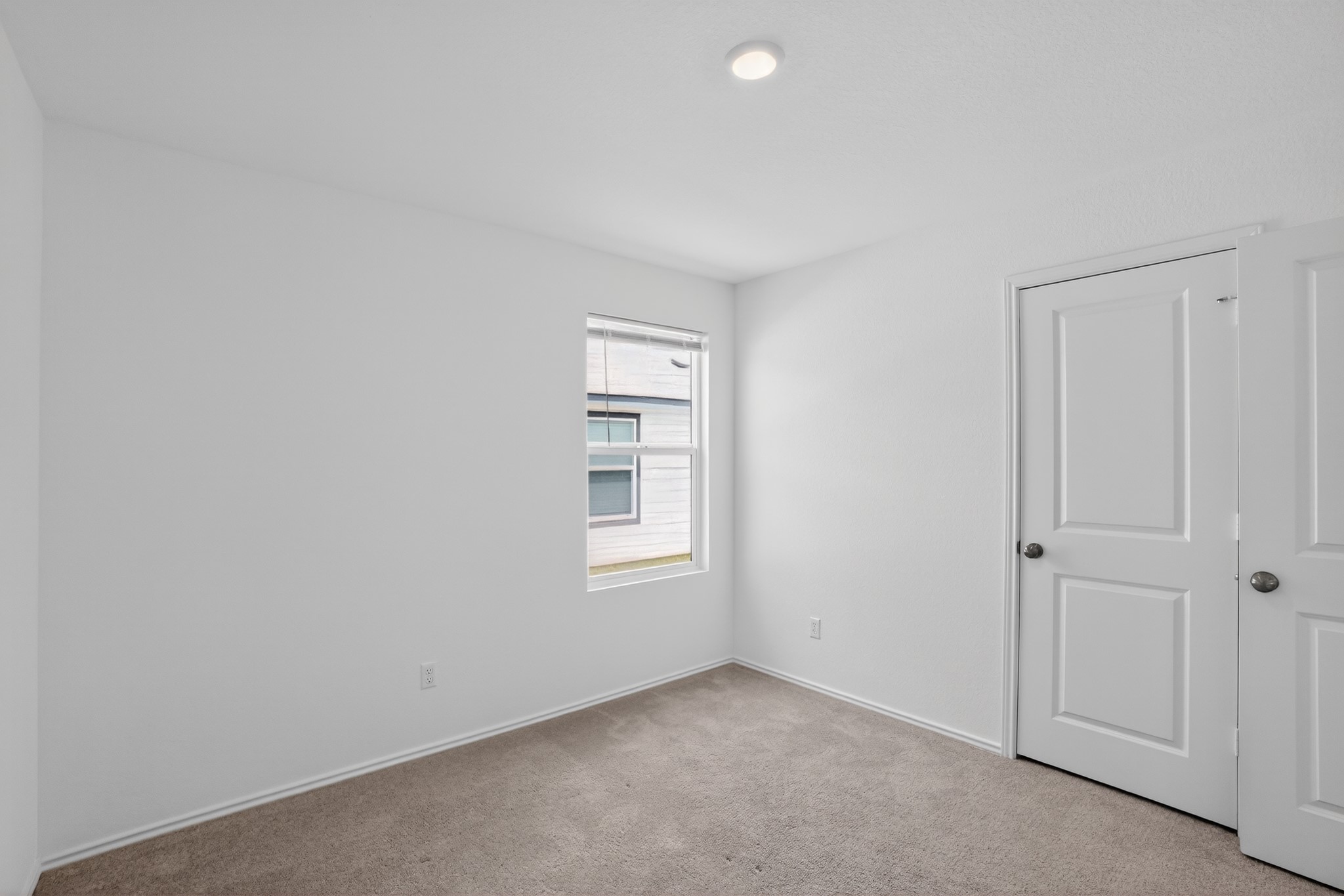 604 Marty Allen Loop Jarrell, TX 76537 - Photo 9 of 15 A well-lit bedroom offering a peaceful retreat, complete with comfortable carpeting and a convenient closet.