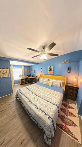 a bedroom with a bed and wooden floor