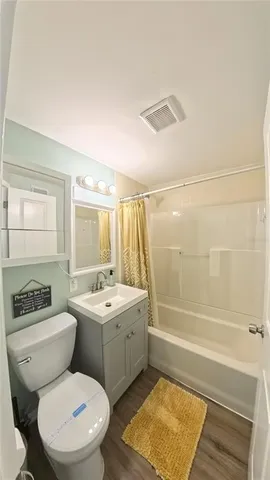 a bathroom with a toilet a sink and a bathtub