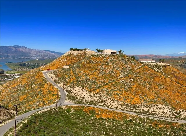 a view of a large building with mountains in the background