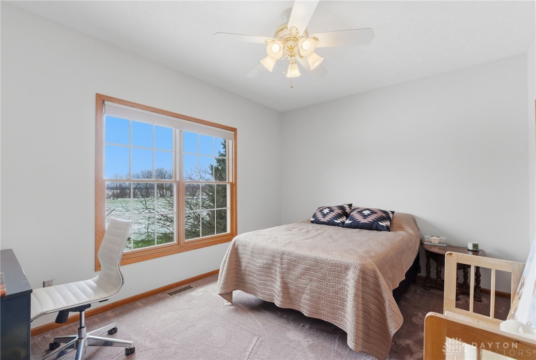 1540 Jasper Road Xenia, OH 45385 - Photo 34 of 91 This cozy bedroom features a bright window and comfortable carpet flooring, creating a relaxing atmosphere.