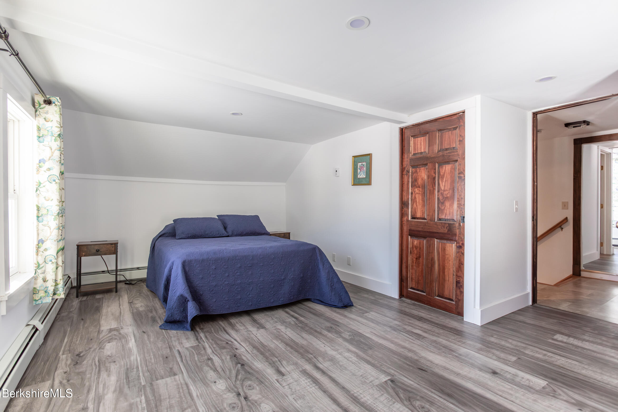 35 Chapman Road Pittsfield, MA 01201 - Photo 27 of 43 a living room with a bed furniture and a wooden floor