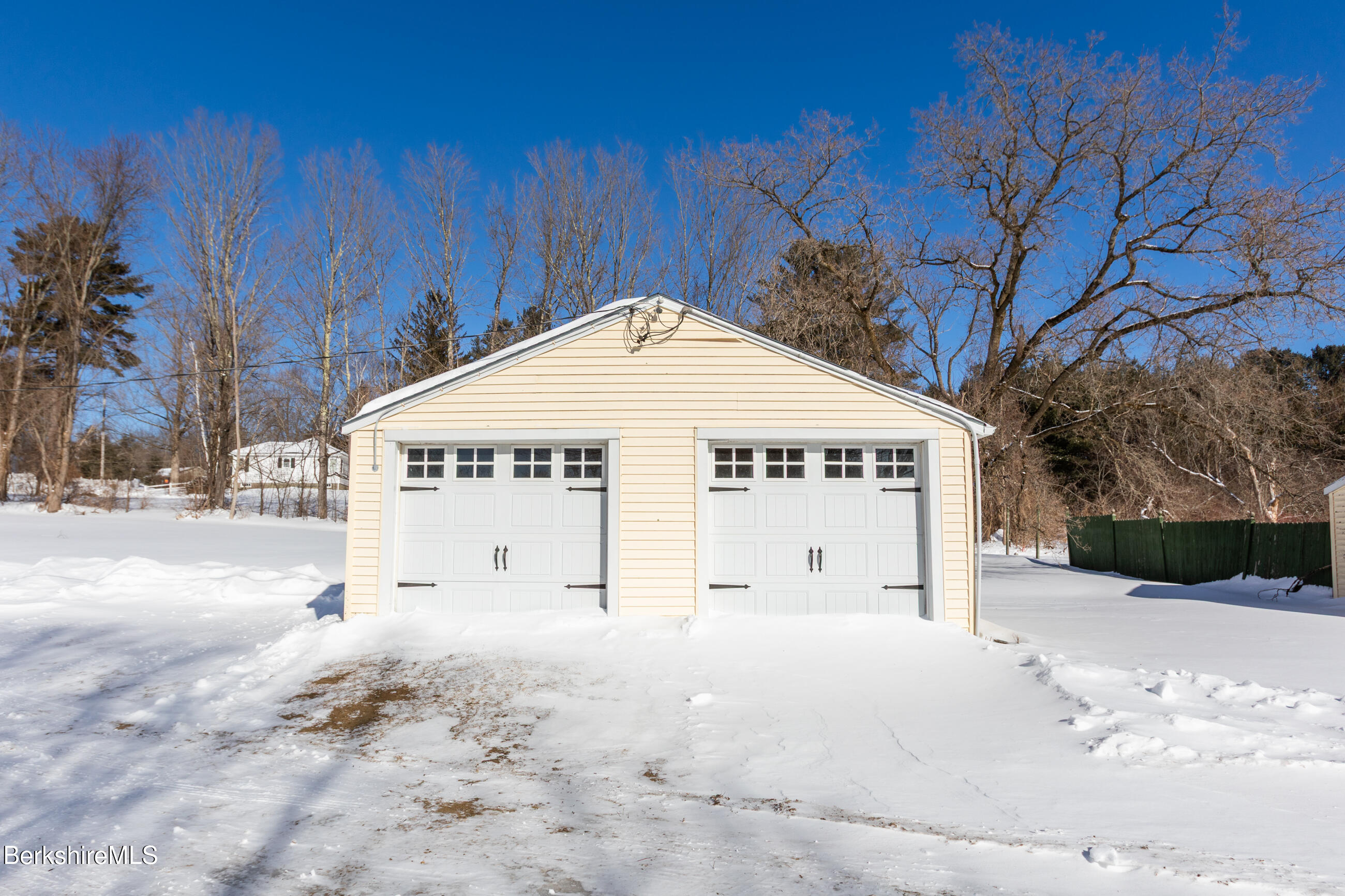 35 Chapman Road Pittsfield, MA 01201 - Photo 34 of 43 a white house with a large tree in front of it