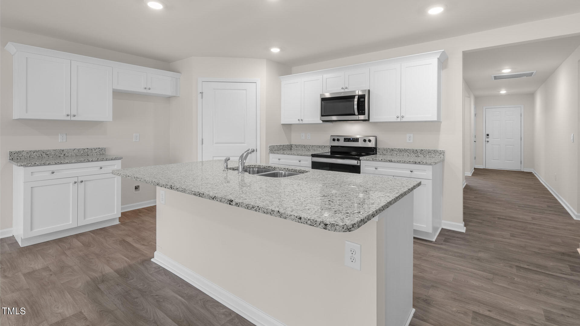 a kitchen with granite countertop cabinets stainless steel appliances a sink and a counter top space