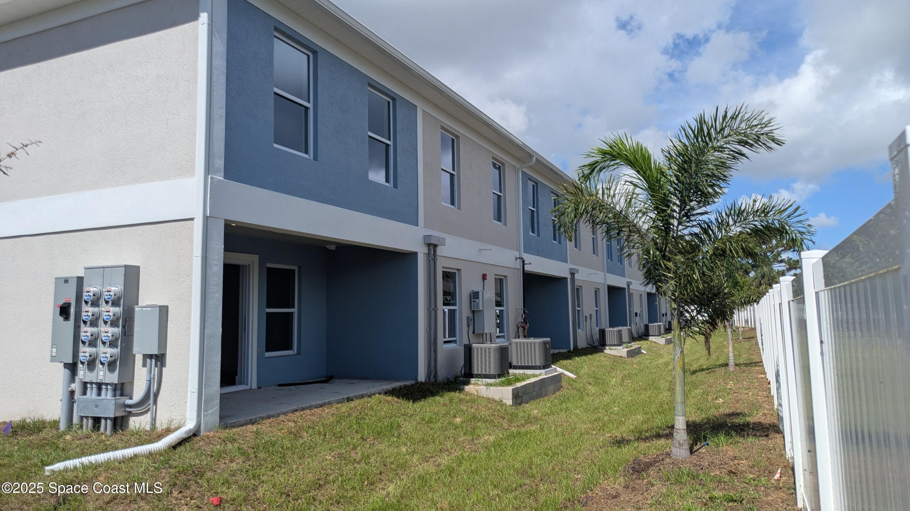 1625 Par Street, Unit 1205 Palm Bay, FL 32905 - Photo 32 of 38 a view of a house with a yard and plants