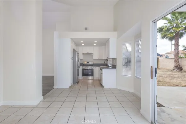 a view of a kitchen with a sink and a refrigerator
