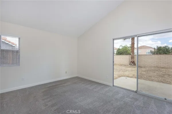 an empty room with sliding glass door