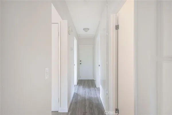 a view of a hallway with wooden floor