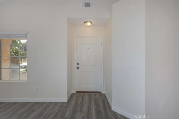 a view of room with window and hardwood floor