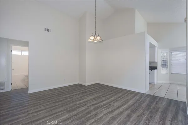a view of a room with wooden floor