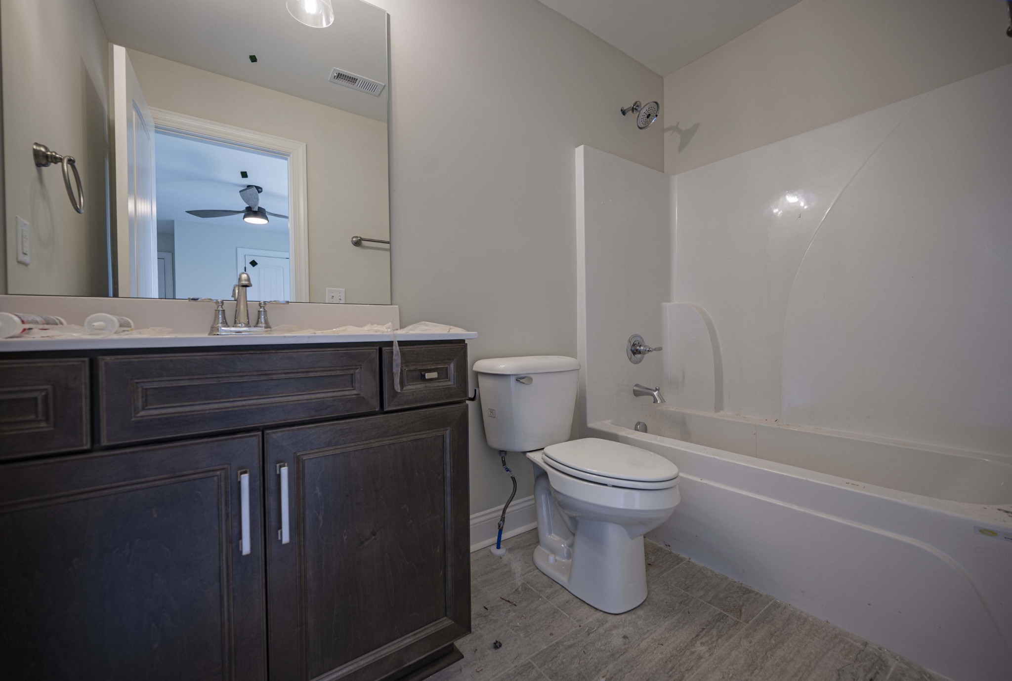 7502 Midland Road Christiana, TN 37037 - Photo 56 of 63 a bathroom with a granite countertop toilet a sink and a mirror