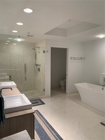a bathroom with a glass shower door