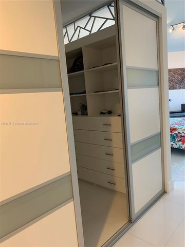 a living room with furniture and a view of kitchen