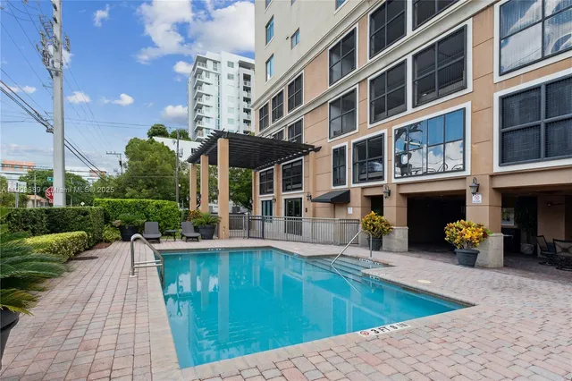 a swimming pool with outdoor seating and yard